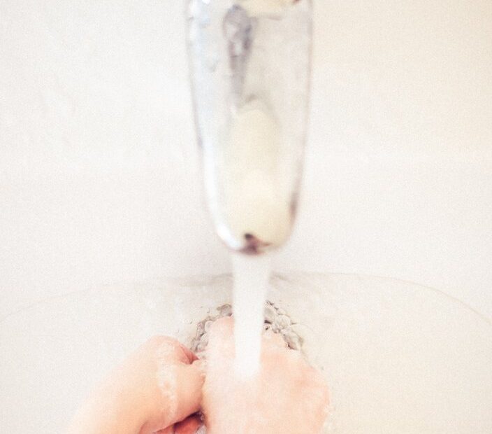 An image of a person with their hands under a tap of running water